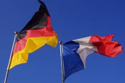 A French and German Flag waving